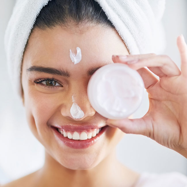 Woman smiling with face cream
